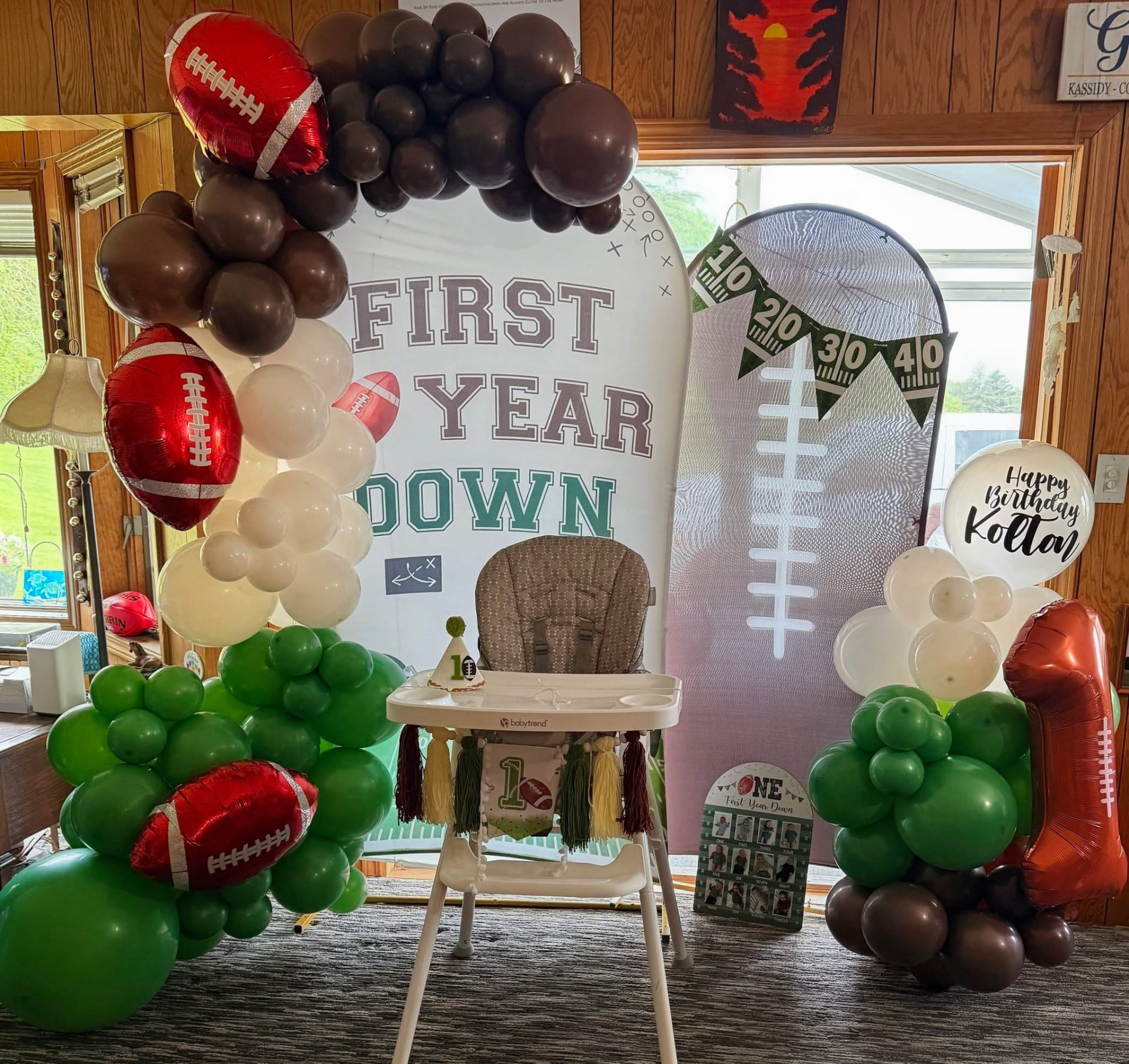 Football themed 'First Year Down' first birthday balloon setup