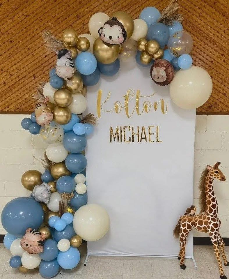 Safari themed blue and gold balloon garland with name backdrop