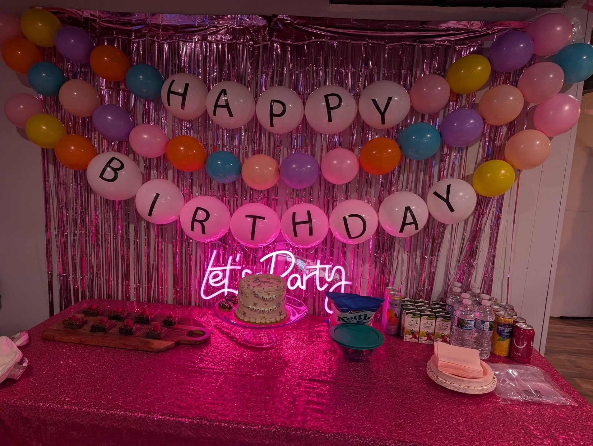 Pink Happy Birthday balloon letter backdrop with neon sign